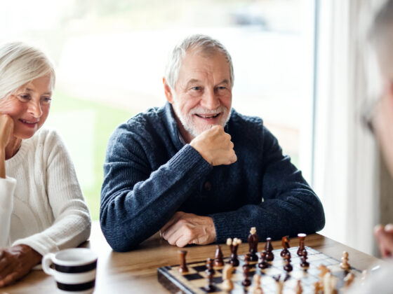 The importance of friendship: Older friends enjoying a game of Chess