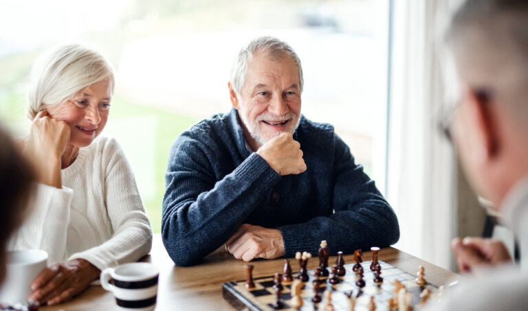 The importance of friendship: Older friends enjoying a game of Chess